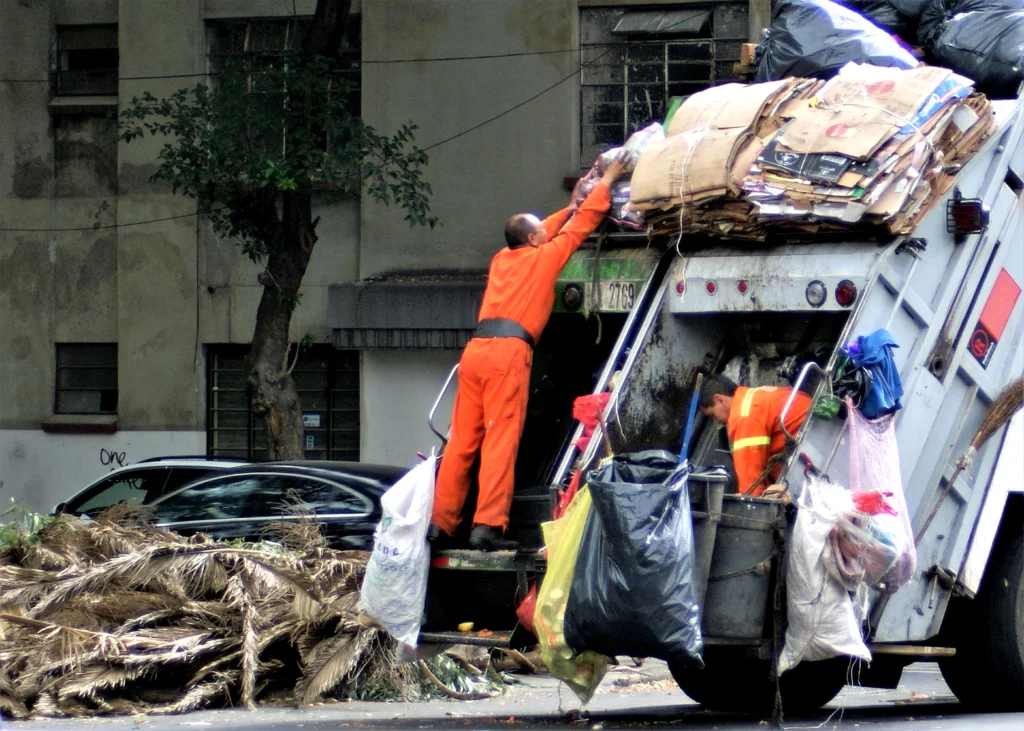 Waste & recycling management workers loading garbage